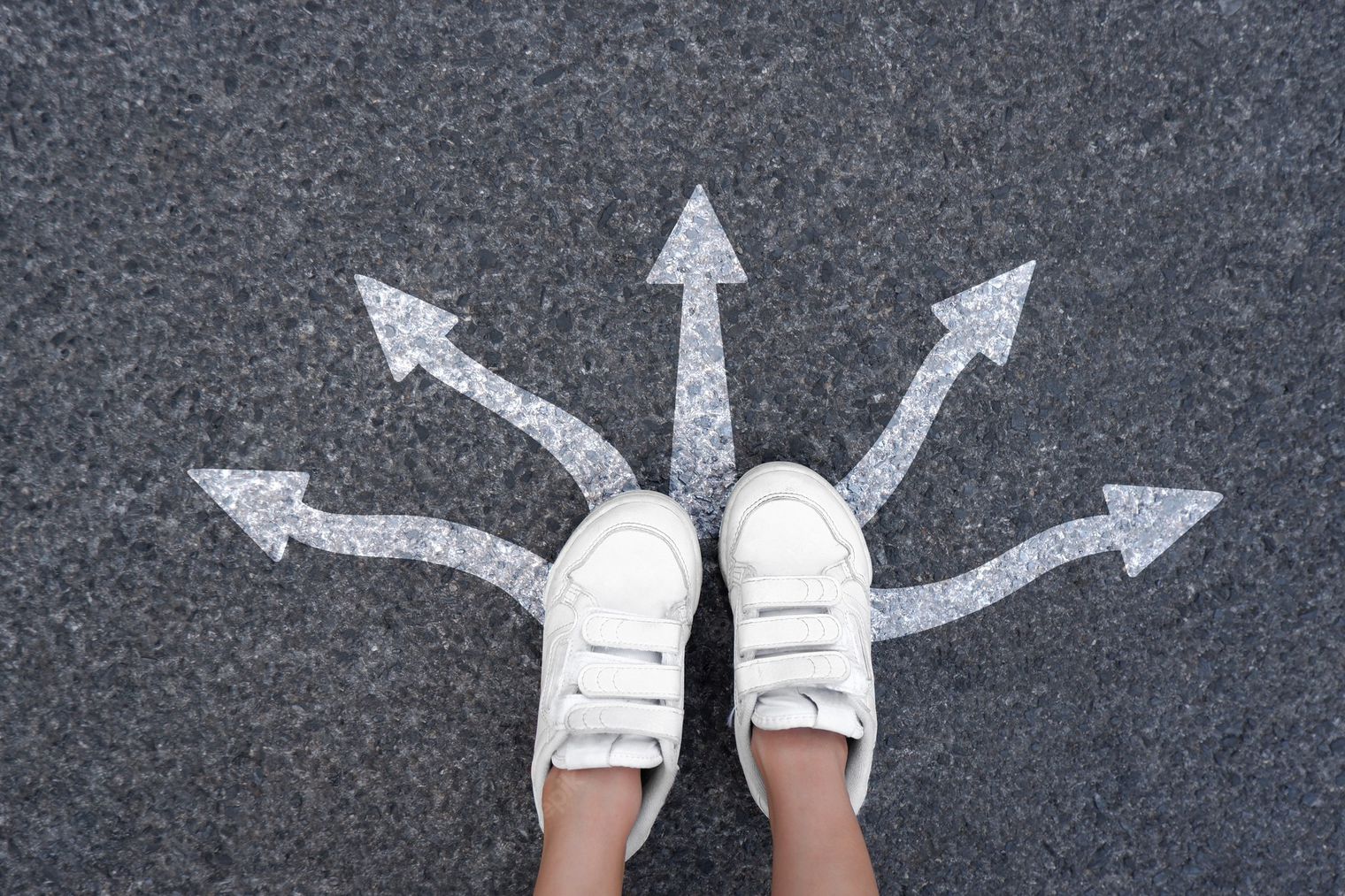 two feet standing before arrows going in many directions