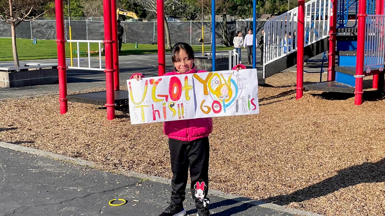 little girl with welcome sign