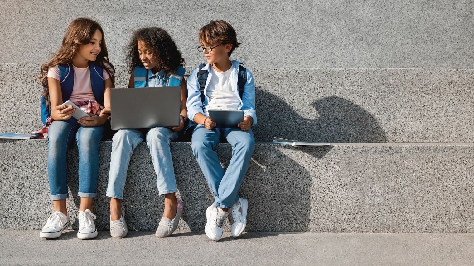 Photo of kids with digital devices
