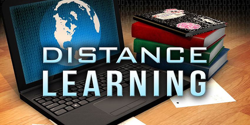 an open laptop with books and words distance learning