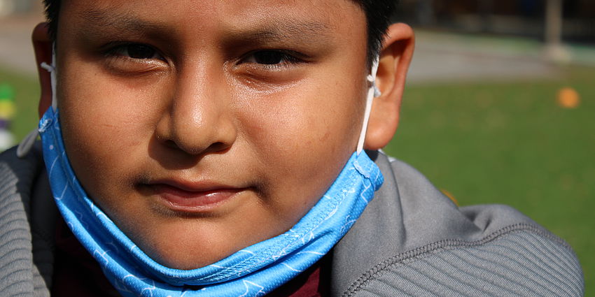 boy with mask on chin