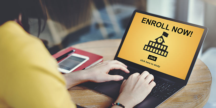 Person at laptop; screen reads