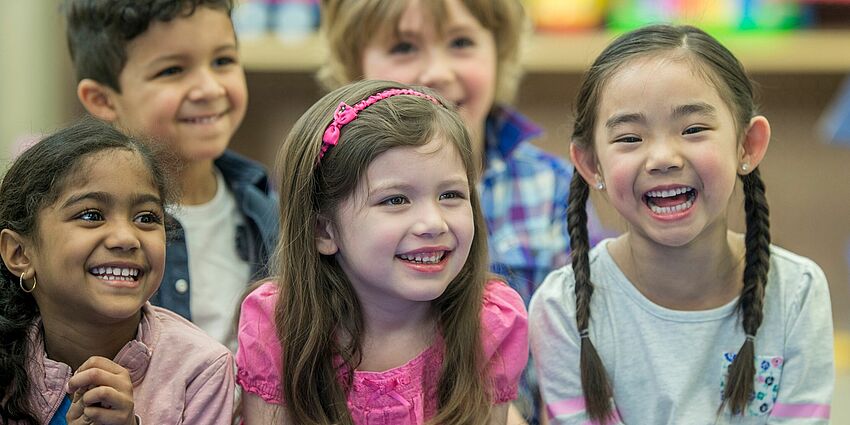 A group of kindergarten children--3 girls and 2 boys-- happy and smiling