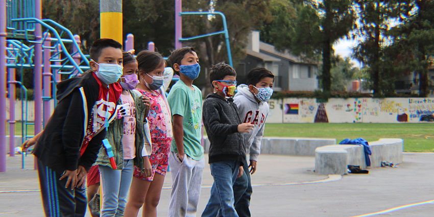 boys and girls line up on the school playground