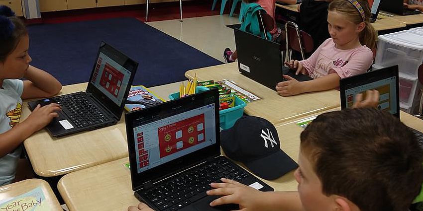 Children using Chromebooks in classroom