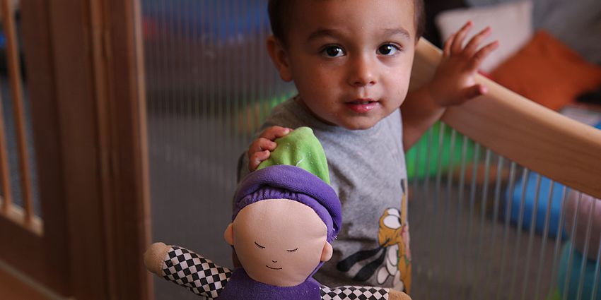 child holding doll