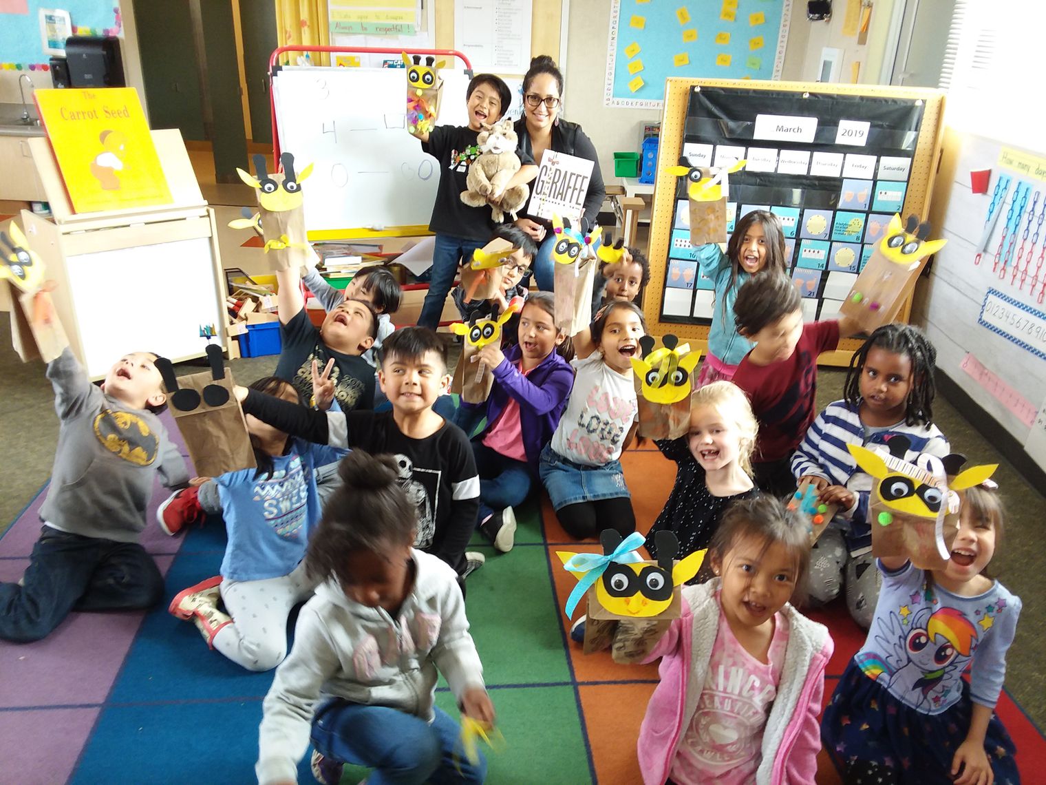 Kindergarten students joined by an adult volunteer reader 
