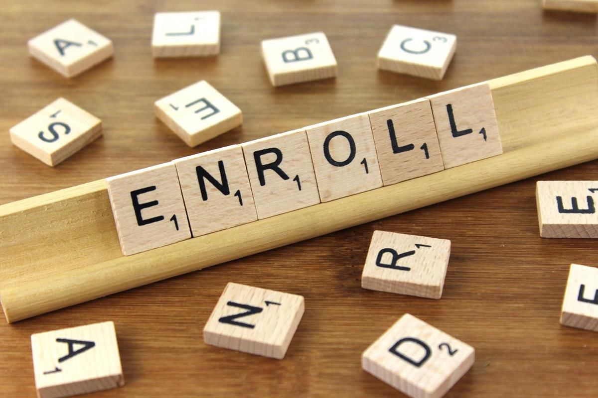 scrabble tiles spelling "enroll"