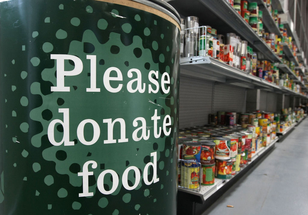 Picture of food donation bin and canned food on shelves