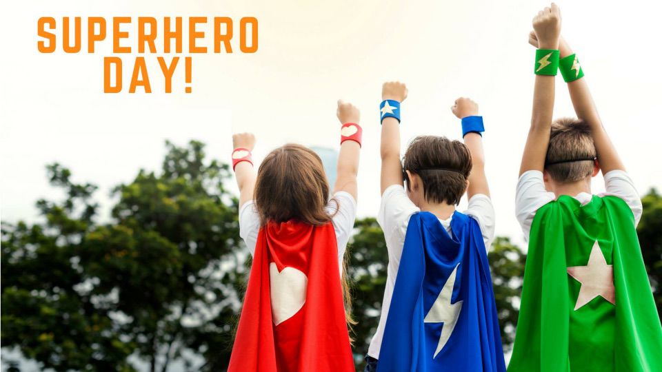 Superhero Day text and students dressed with superhero cape.