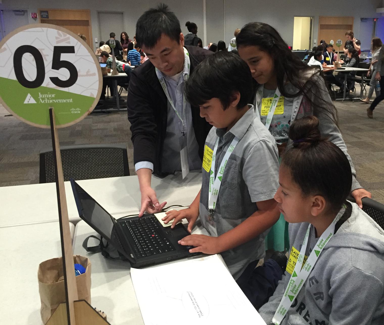 Students at Cisco working on laptop